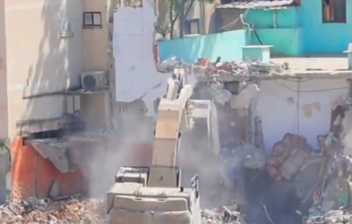 Thumbnail preview image for the video titled: Israeli armored caterpillar excavator continue their wide-scale razing of Palestinian homes during the ongoing invasion in Nur Shams refugee camp