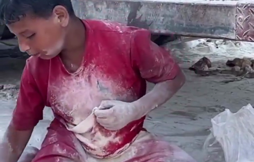 Thumbnail preview image for the video titled: A starved child searches through the dirt to collect scattered remnants of flour