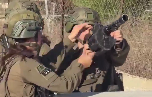 Thumbnail preview image for the video titled: An Israeli female soldier trained to fire tear gas at journalists covering the olive harvest in Kobar