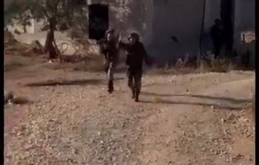 Thumbnail preview image for the video titled: Israeli soldiers firing tear gas towards journalists during their coverage of an olive harvest in Kobar