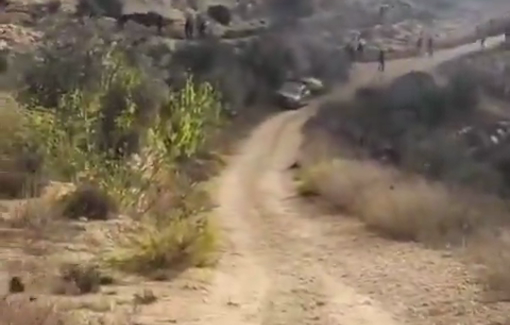 Thumbnail preview image for the video titled: Settlers attack olive harvesters and torch two vehicles in Turmus Ayya