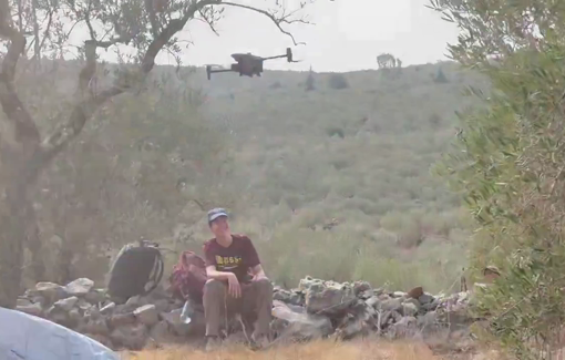 Thumbnail preview image for the video titled: An Israeli drone hits and injures an activist during an olive harvest near the Revava settlement in Deir Istiya, Salfit Governorate