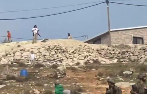 Thumbnail preview image for the video titled: Israeli settlers and soldier harassing local Palestinian residents in Khallet Al-Natsh